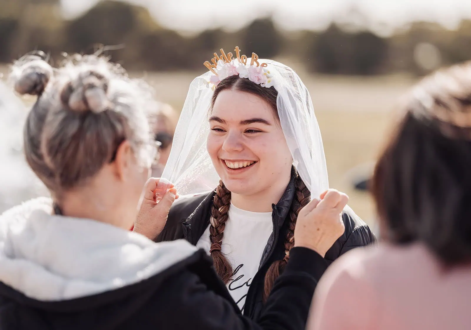 monarto delta force bucks vs hens paintball party 1 Bride-to-be smiling as veil is adjusted during outdoor pre-wedding celebration.