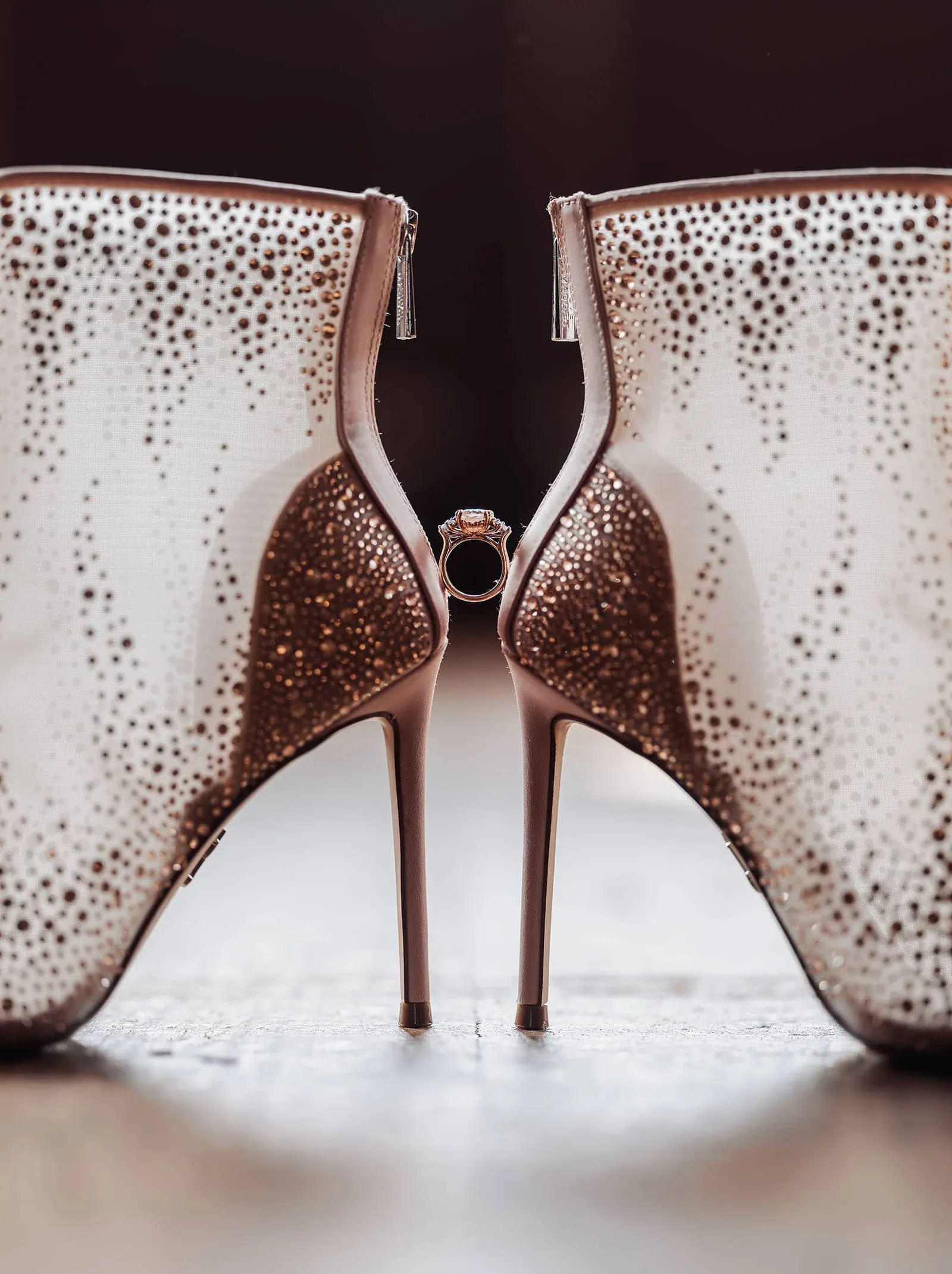 engagement rings under $2,000: 7 designs that don't look cheap 7 Elegant high-heeled shoes and engagement ring on reflective surface.