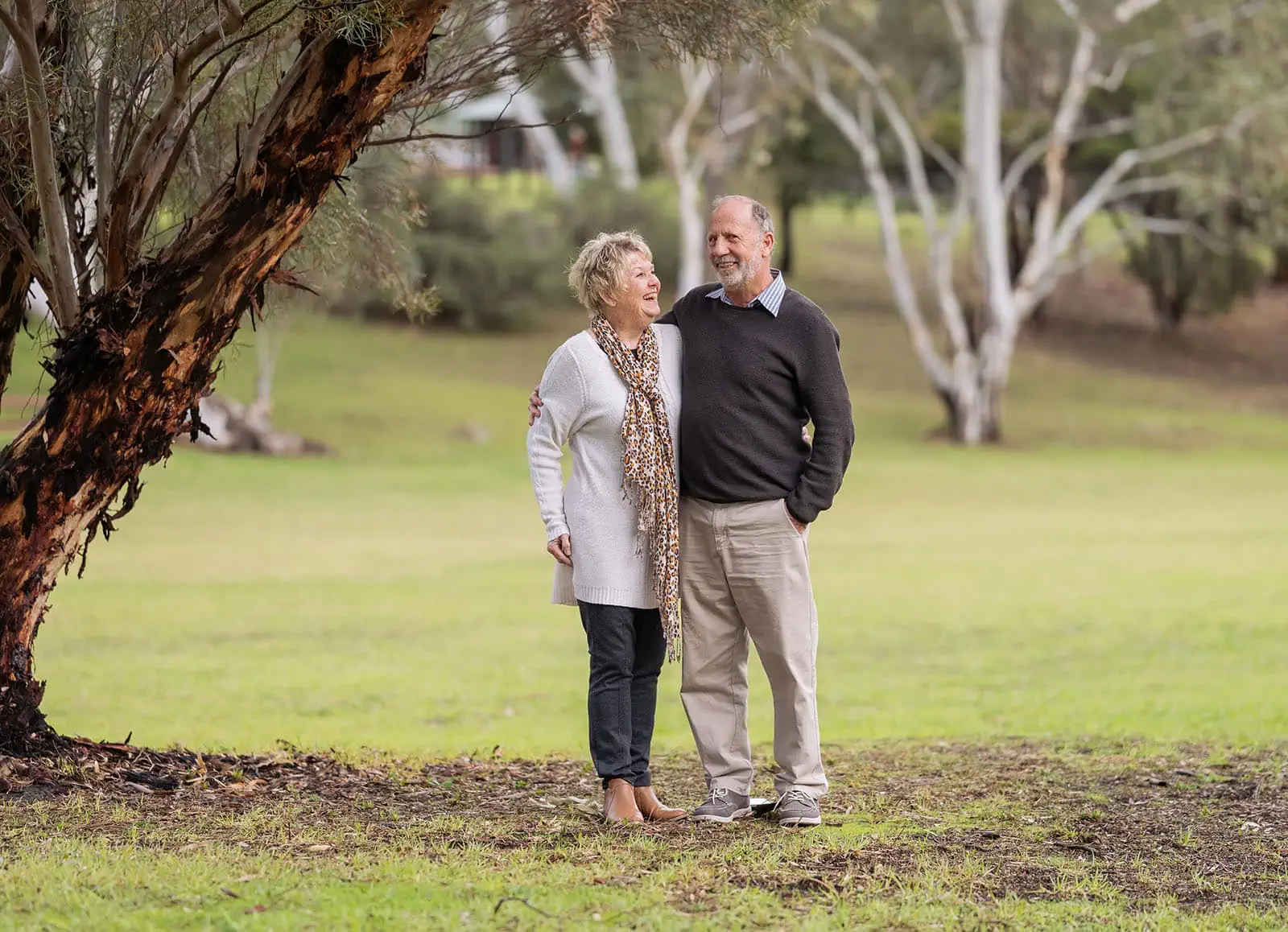baby joshua's newborn photo shoot 34 Elderly couple enjoying nature in park, displaying affection and happiness.