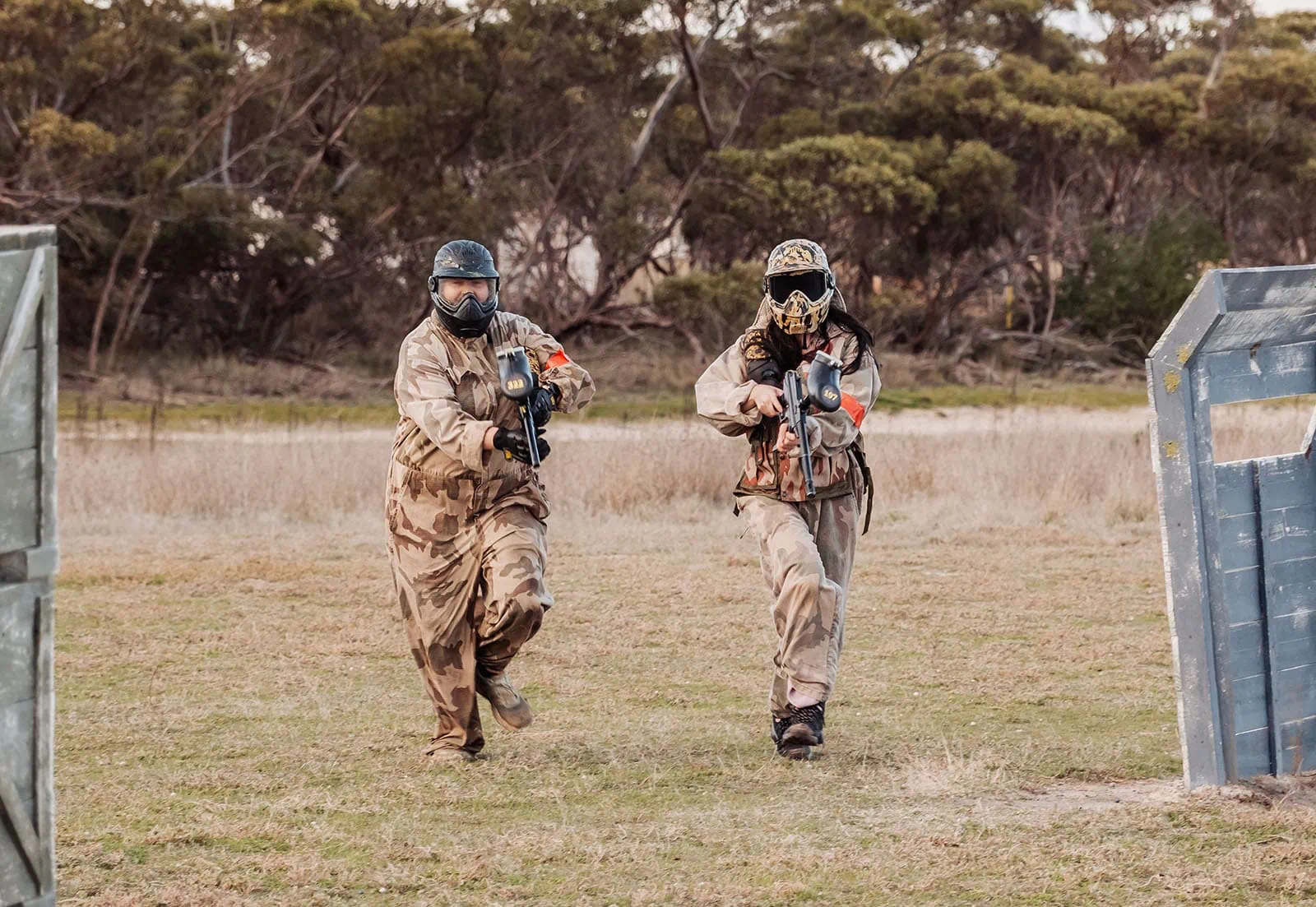 monarto delta force bucks vs hens paintball party 38 Two players in camouflage gear during an intense forest paintball game.
