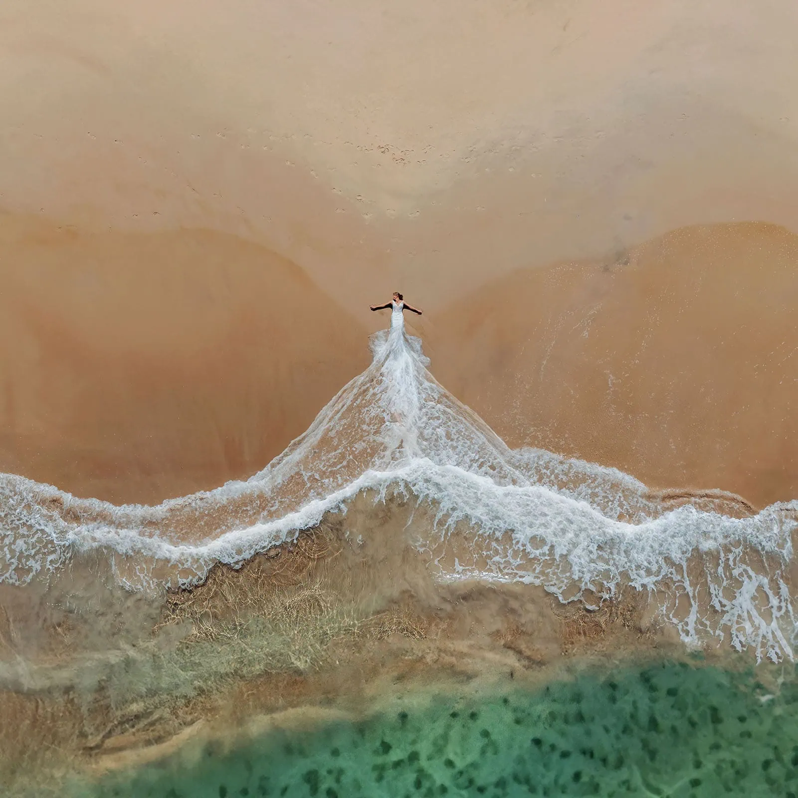 pt noarlunga underwater wreck the dress shoot - jess & jack 6 Aerial view of lone figure on sandy beach with turquoise sea, conveying tranquility and nature.