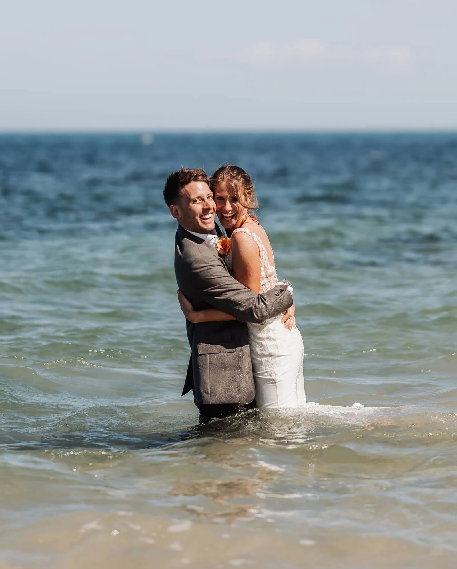 pt noarlunga underwater wreck the dress shoot - jess & jack 9 Joyful couple in wedding attire embracing in the ocean at scenic coastal destination.