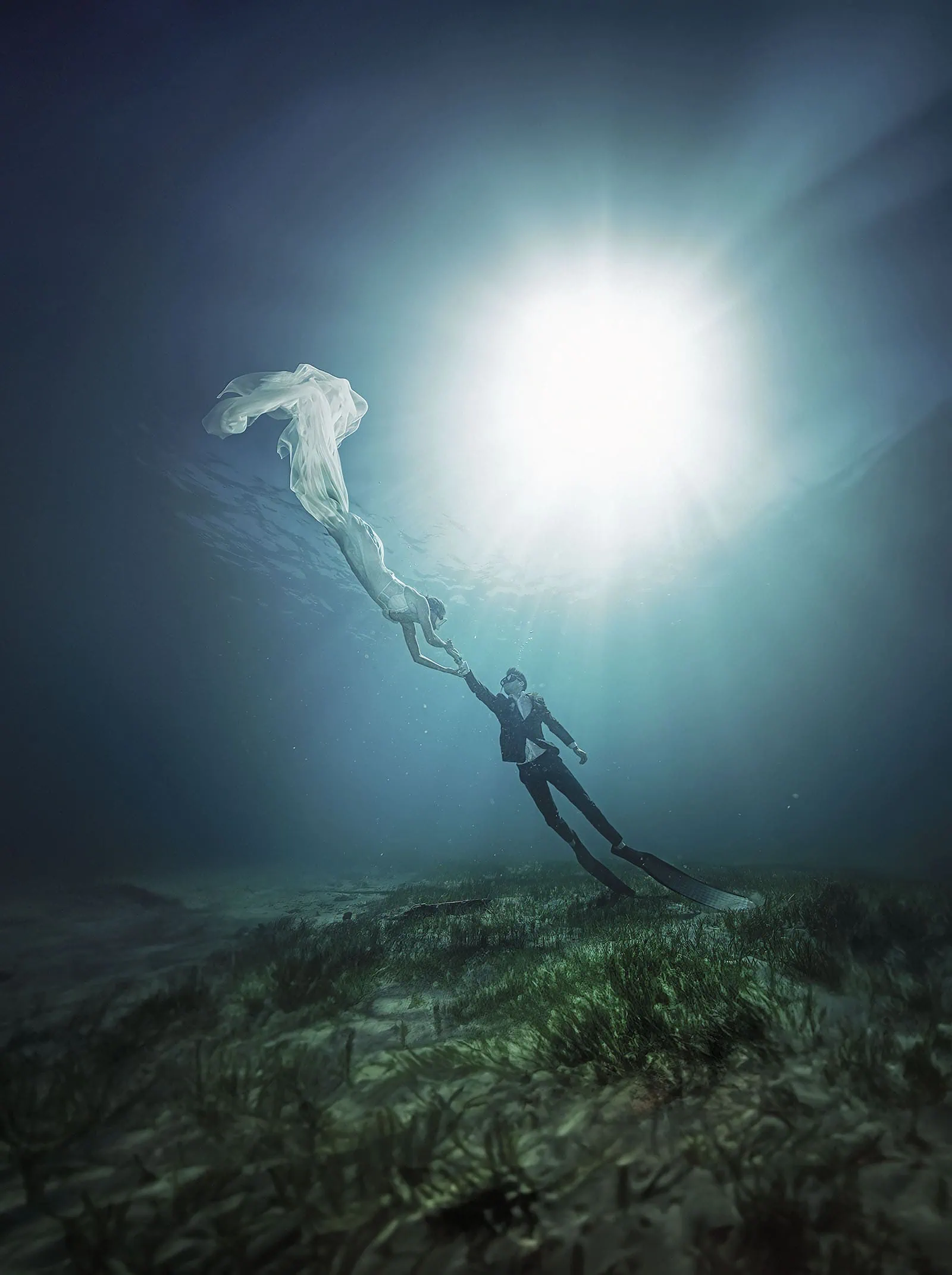 pt noarlunga underwater wreck the dress shoot - jess & jack 11 Elegant underwater dance scene with couple in formal attire, illuminated by sunlight.