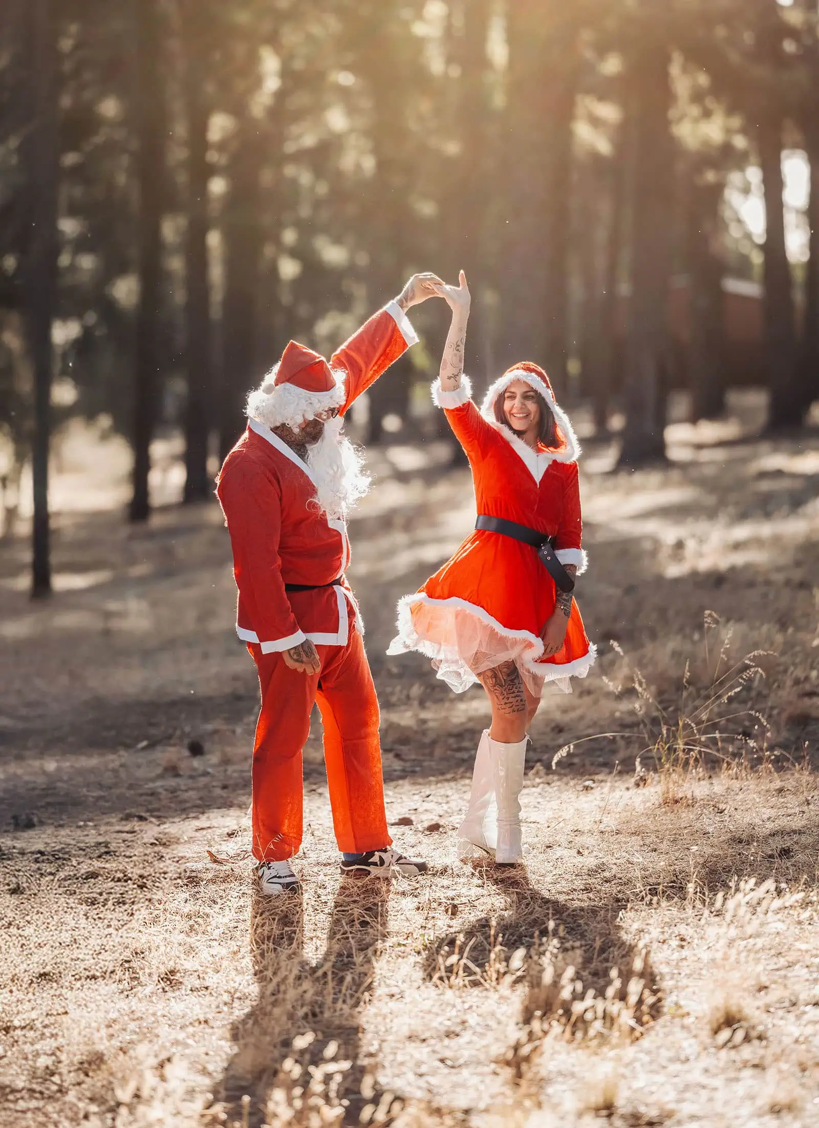 last minute father christmas photoshoot 44 Santa and Mrs. Claus dancing joyfully in a sunlit forest.