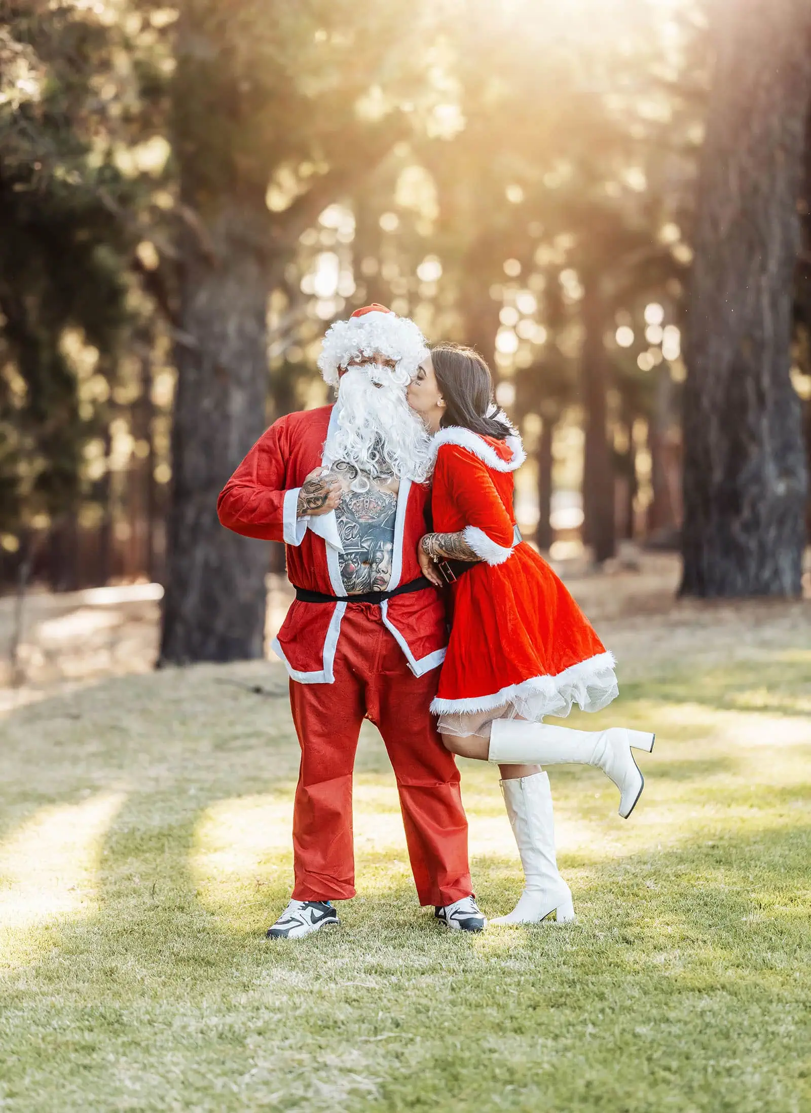 last minute father christmas photoshoot 46 Santa and Mrs. Claus in a sunny, festive forest, showcasing tattoos and romance.