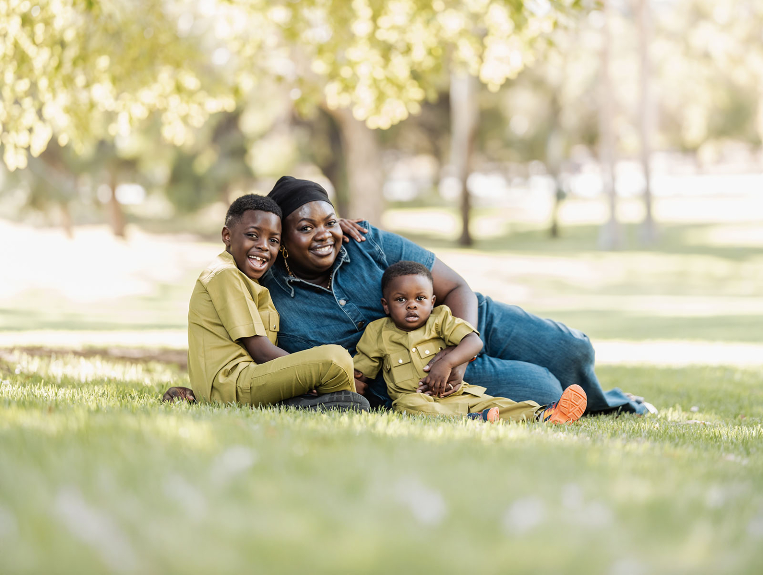 family photoshoot in veale gardens 18 Mother and sons enjoying a sunny day in the park, surrounded by nature.