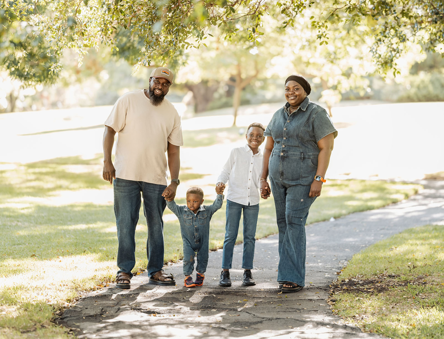 family photoshoot in veale gardens 12 Family enjoying a sunny park walk with kids, nature, and happiness.