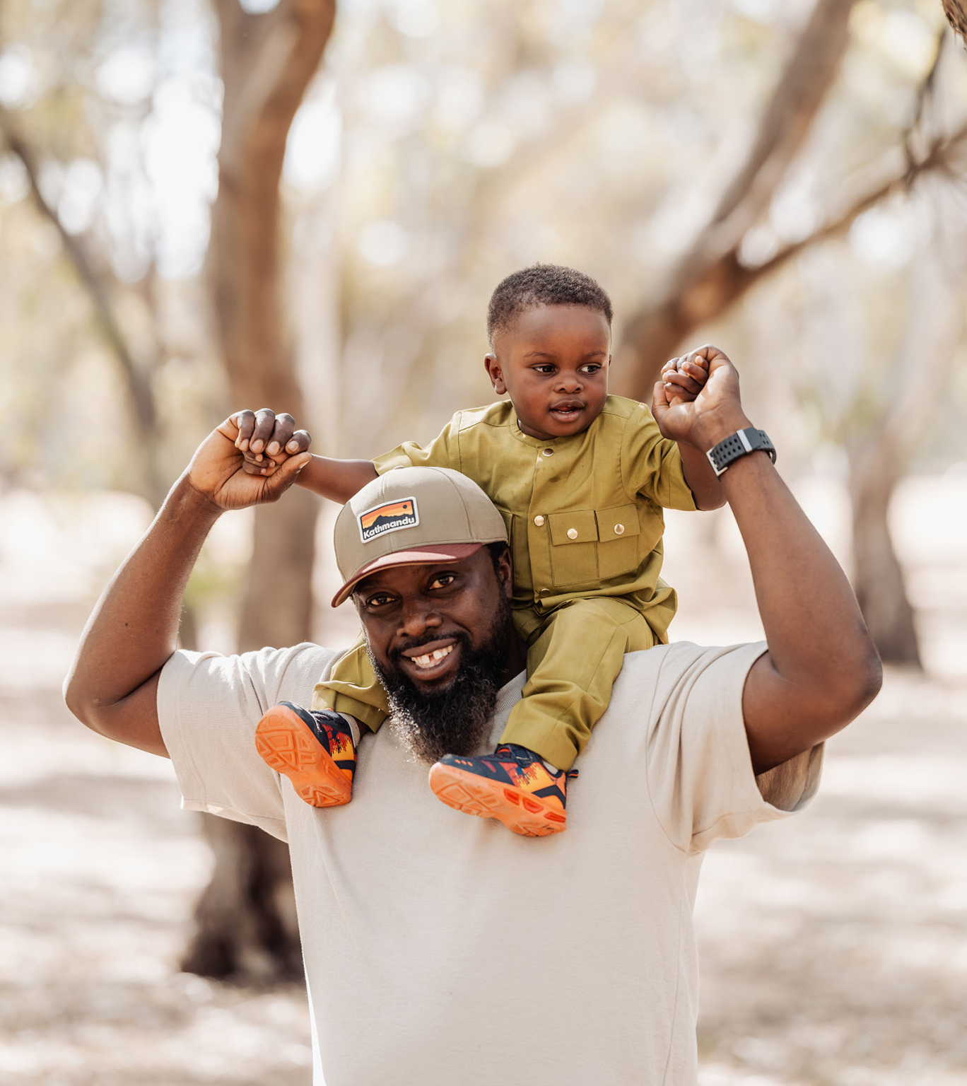 family photoshoot in veale gardens 22 Father and son enjoying a joyful moment outdoors in nature.