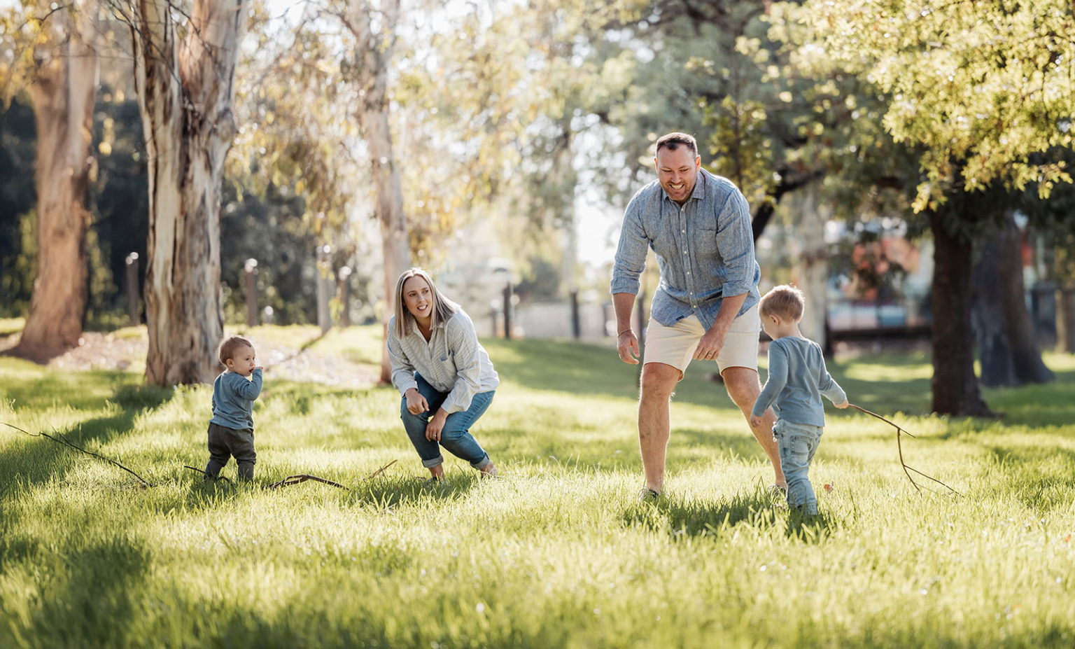 veale gardens family photography 98 Family enjoying playful day outdoors in lush sunlit park.
