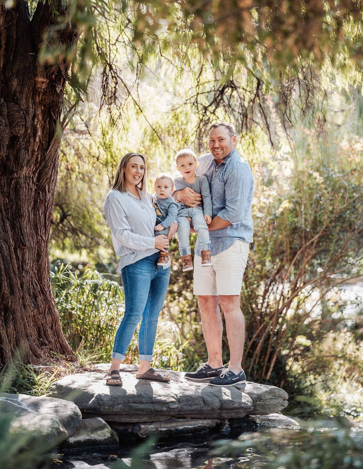veale gardens family photography 101 Family enjoying nature in a serene, sunny outdoor setting with lush greenery.