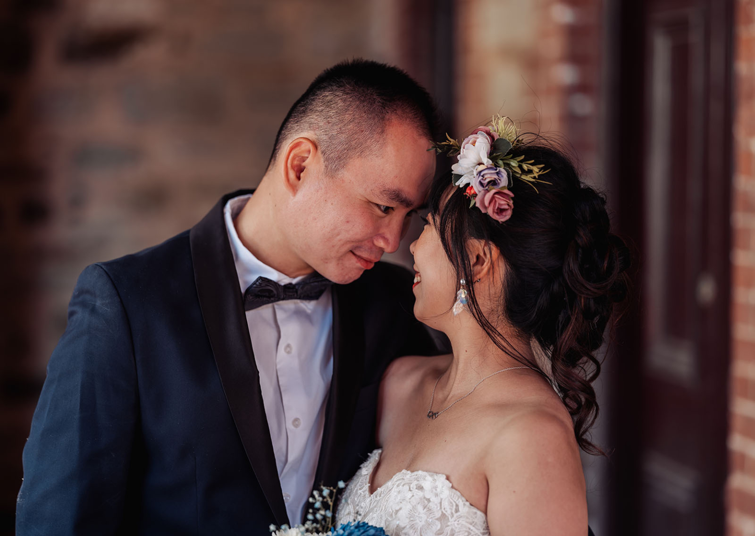 bumbunga lake photoshoot - tina & eric 57 A loving couple in elegant wedding attire sharing an intimate moment with floral accents.