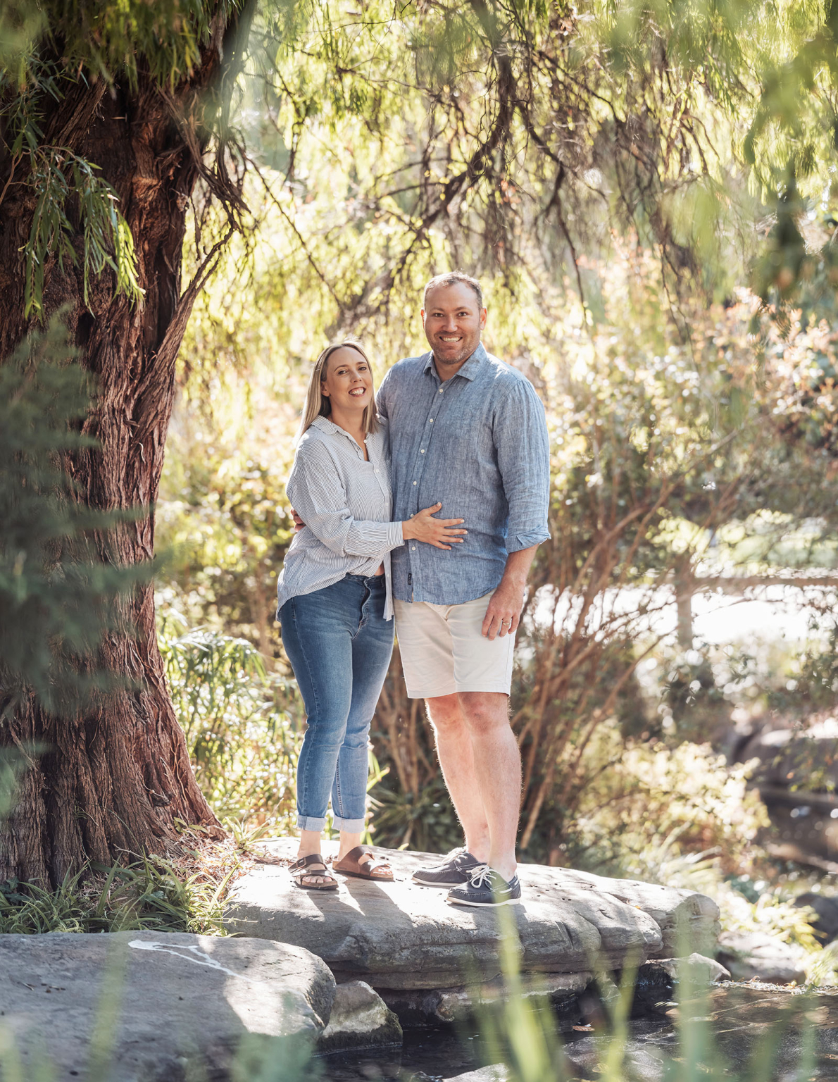 veale gardens family photography 104 Couple on rock in lush park setting, enjoying tranquility and natures beauty.