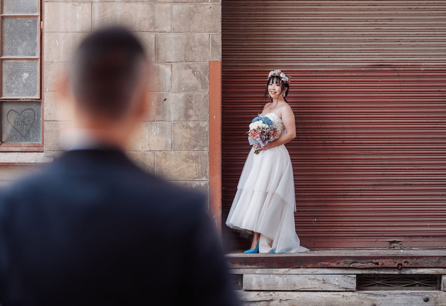 bumbunga lake photoshoot - tina & eric 51 Bride in white gown with floral crown, blue shoes, urban backdrop, bouquet of blue and pink flowers.