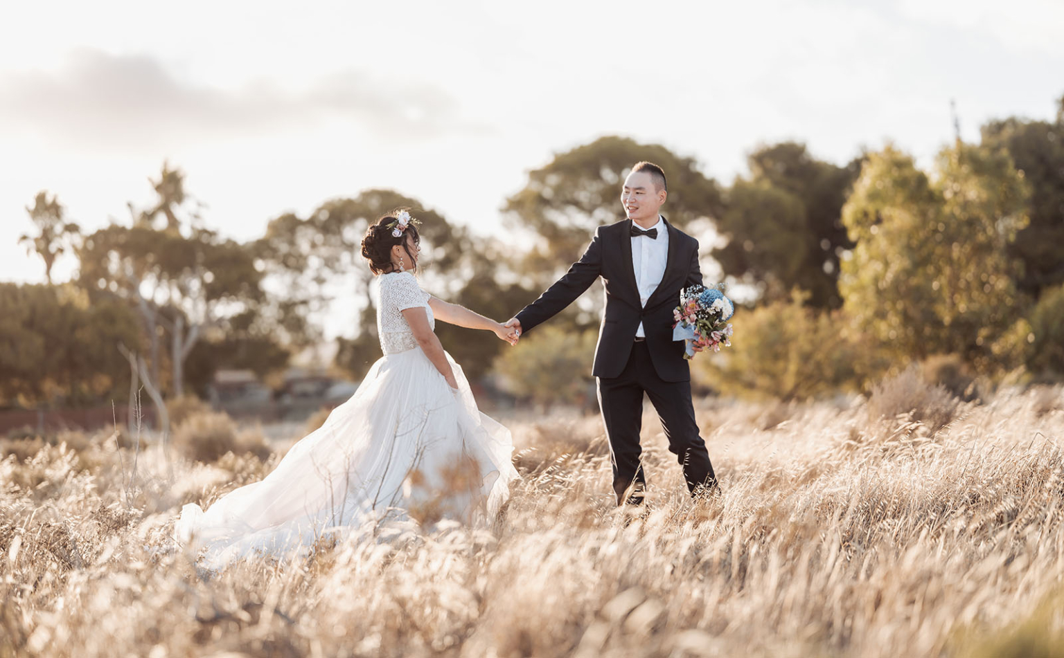 bumbunga lake photoshoot - tina & eric 84 Bride and groom in sunlit field, embracing love amidst natures golden glow.