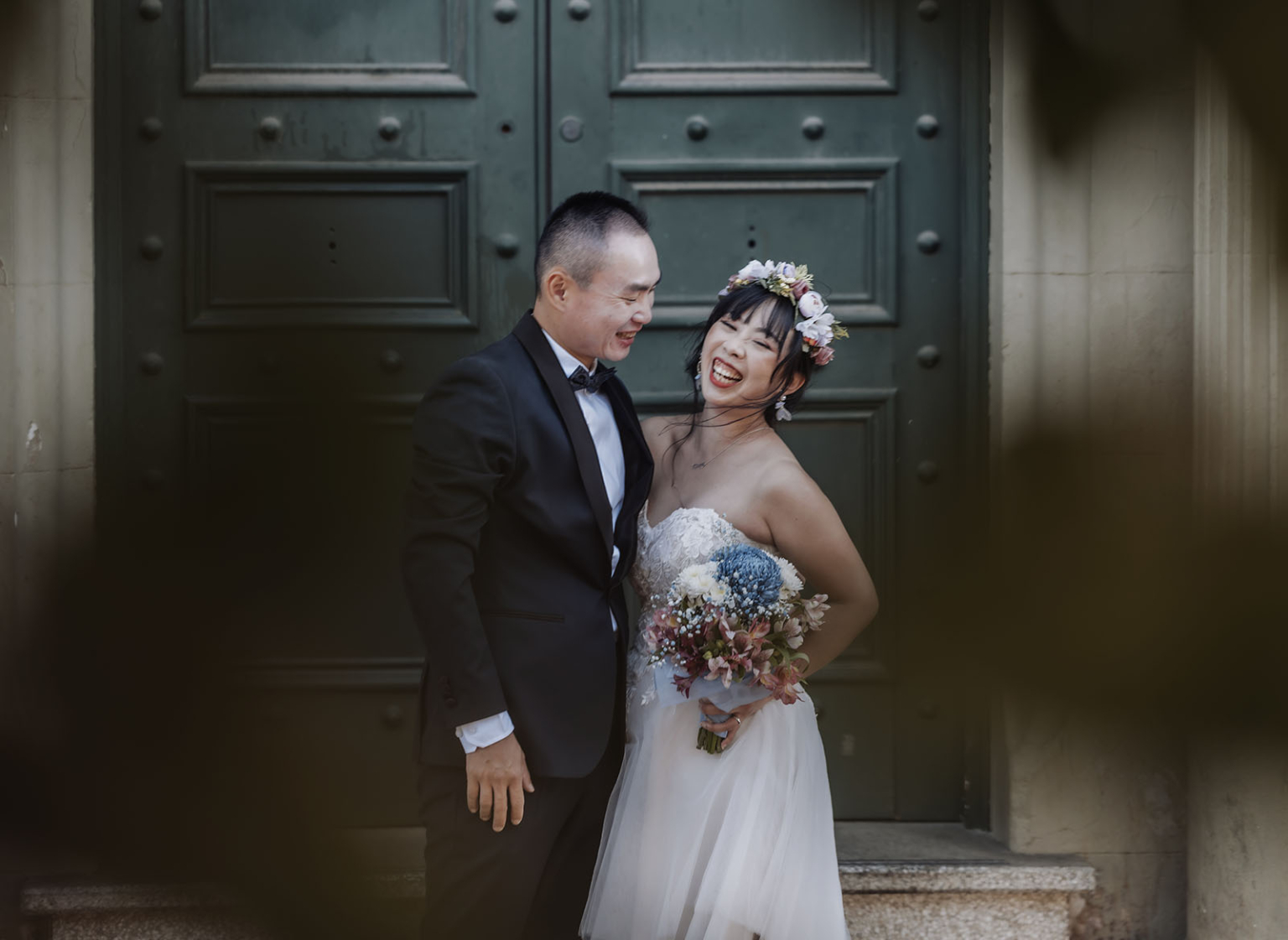 bumbunga lake photoshoot - tina & eric 62 Joyful wedding couple laughing in front of ornate green door with floral details.