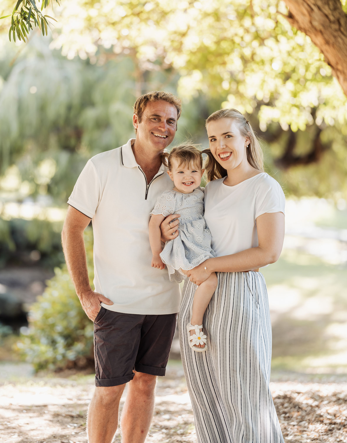 veale gardens family photoshoot 21 Happy family enjoying a sunny day in a lush green park.