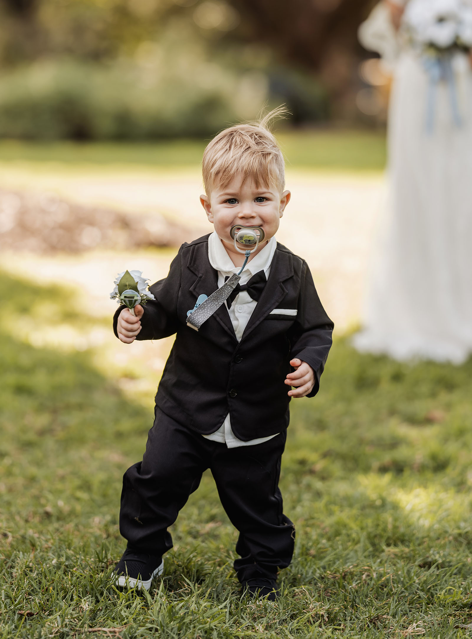 botanic gardens adelaide wedding - melanie & adrian 236 Boy in formal suit at wedding ceremony.