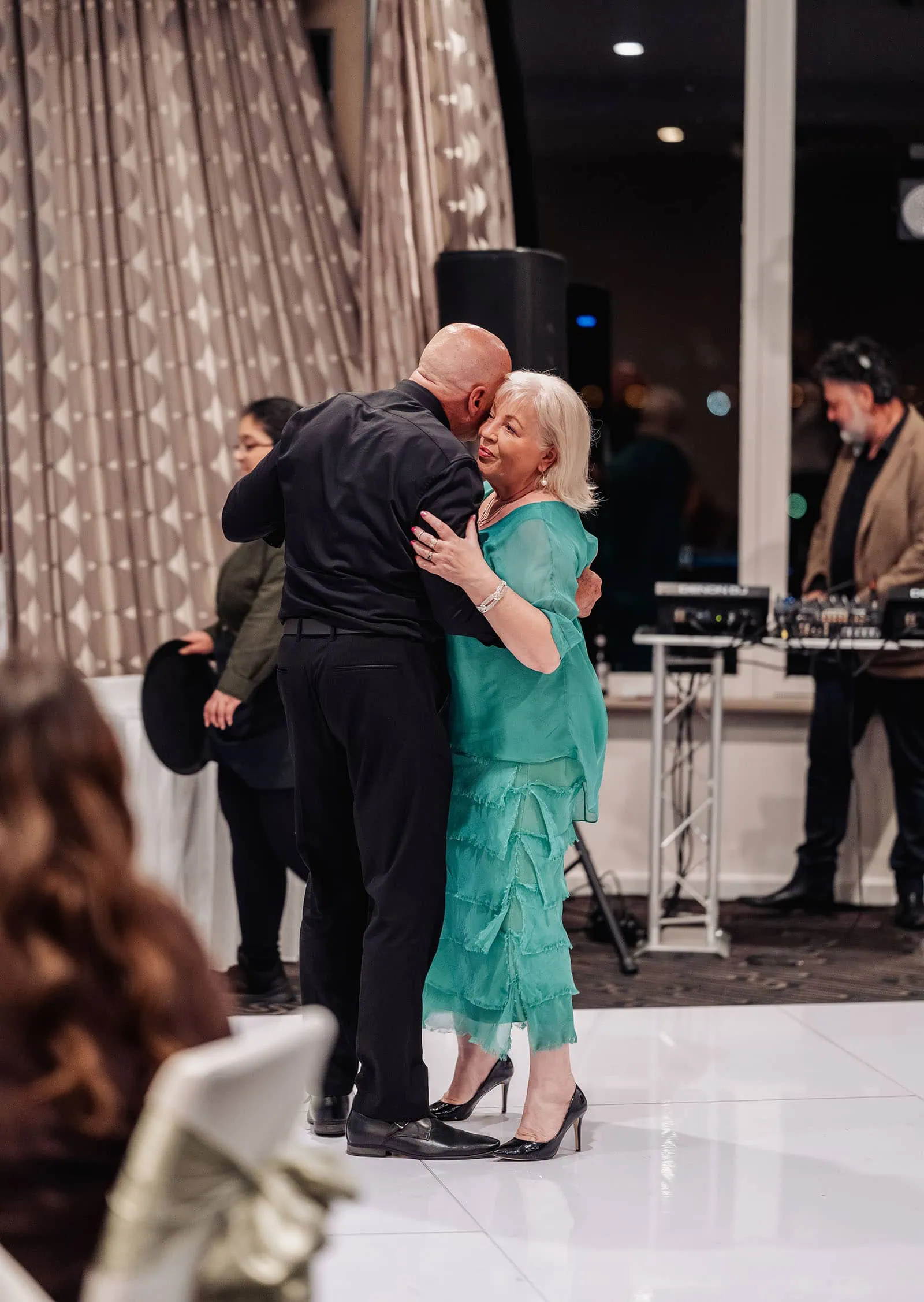 botanic gardens adelaide wedding - melanie & adrian 273 Elegant couple dancing closely at a romantic evening event.