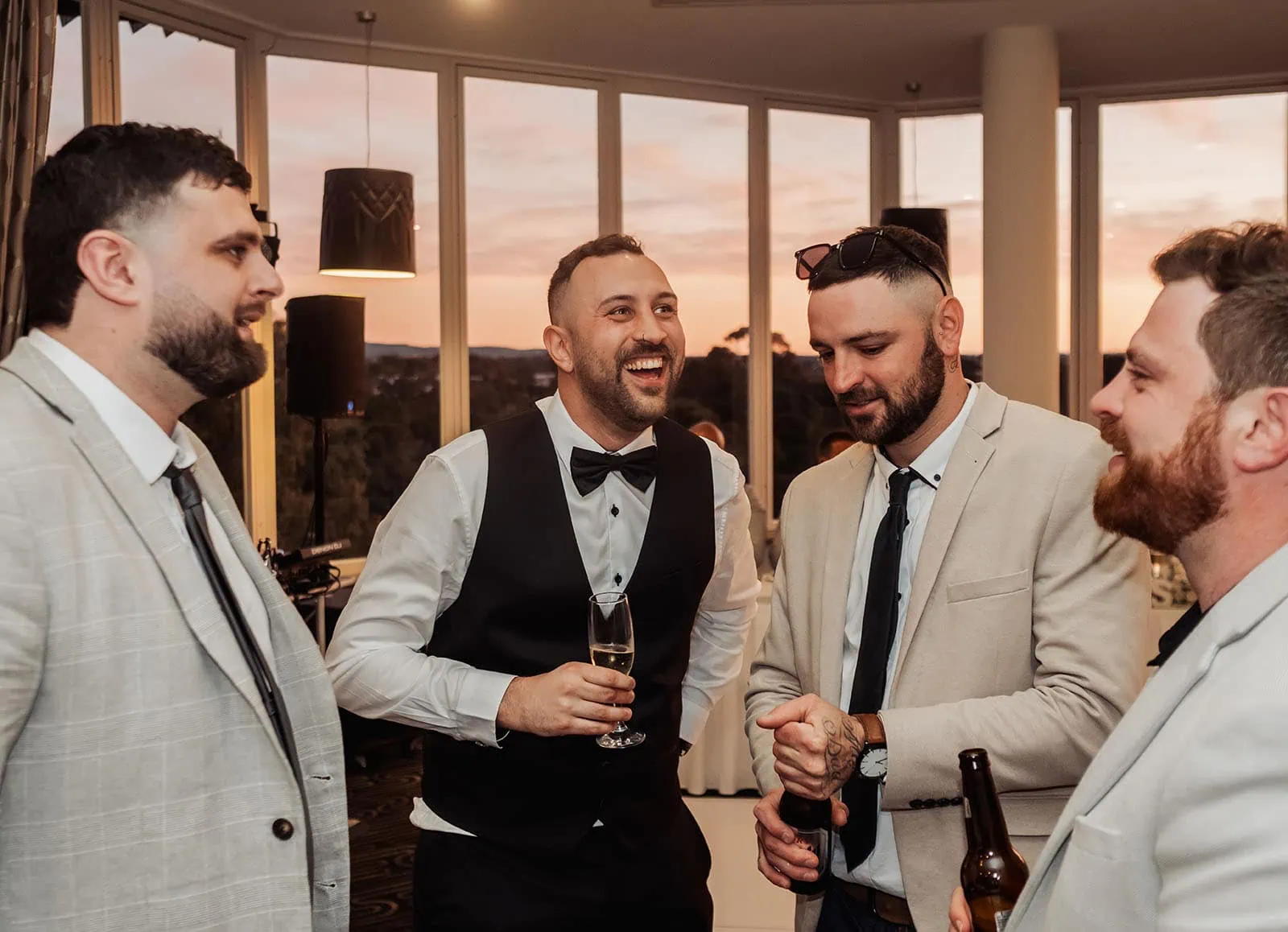 botanic gardens adelaide wedding - melanie & adrian 268 Men at a formal social event in suits, networking and conversing.