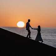 pt willunga beach engagement shoot – sarah & major 3 Silhouetted couple at sunset by the ocean, sharing a moment of connection and tranquility.