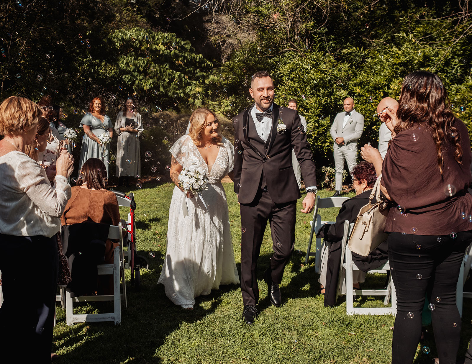botanic gardens adelaide wedding - melanie & adrian 231 Outdoor wedding ceremony with beautiful floral decorations and seated guests.