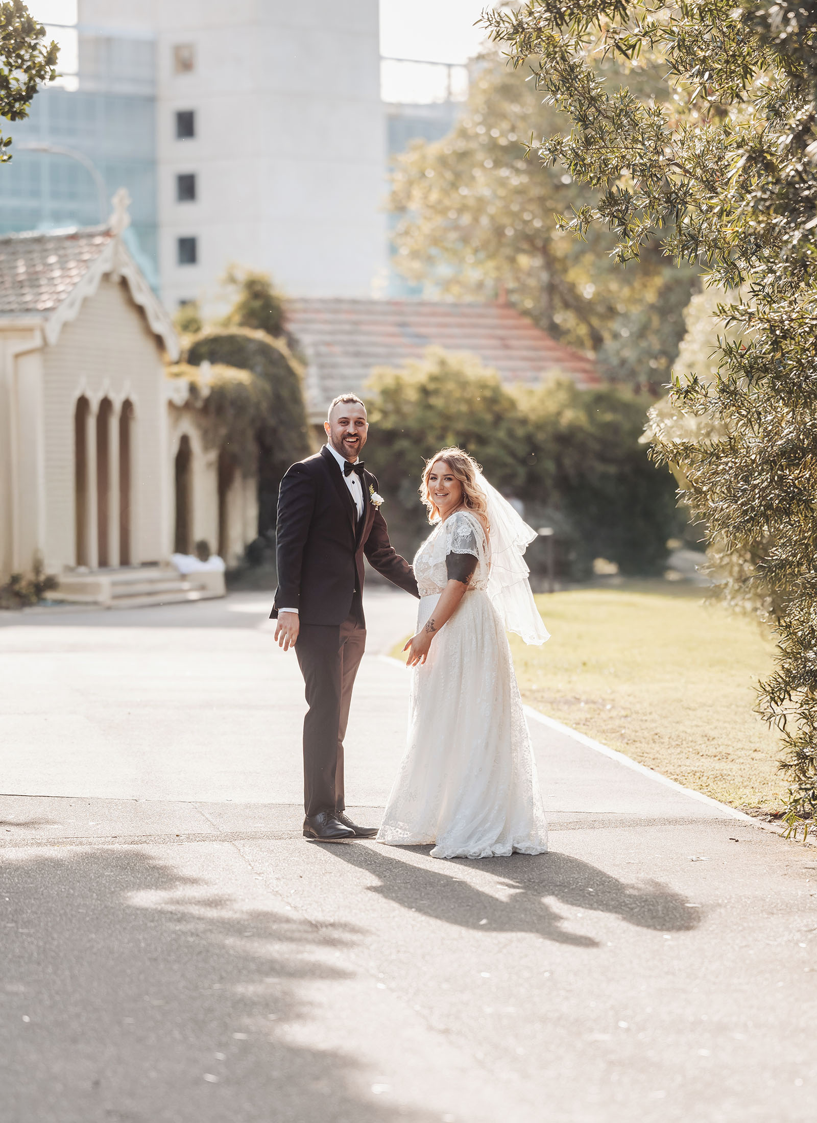 botanic gardens adelaide wedding - melanie & adrian 248 Bride and groom embrace in scenic outdoor wedding portrait.