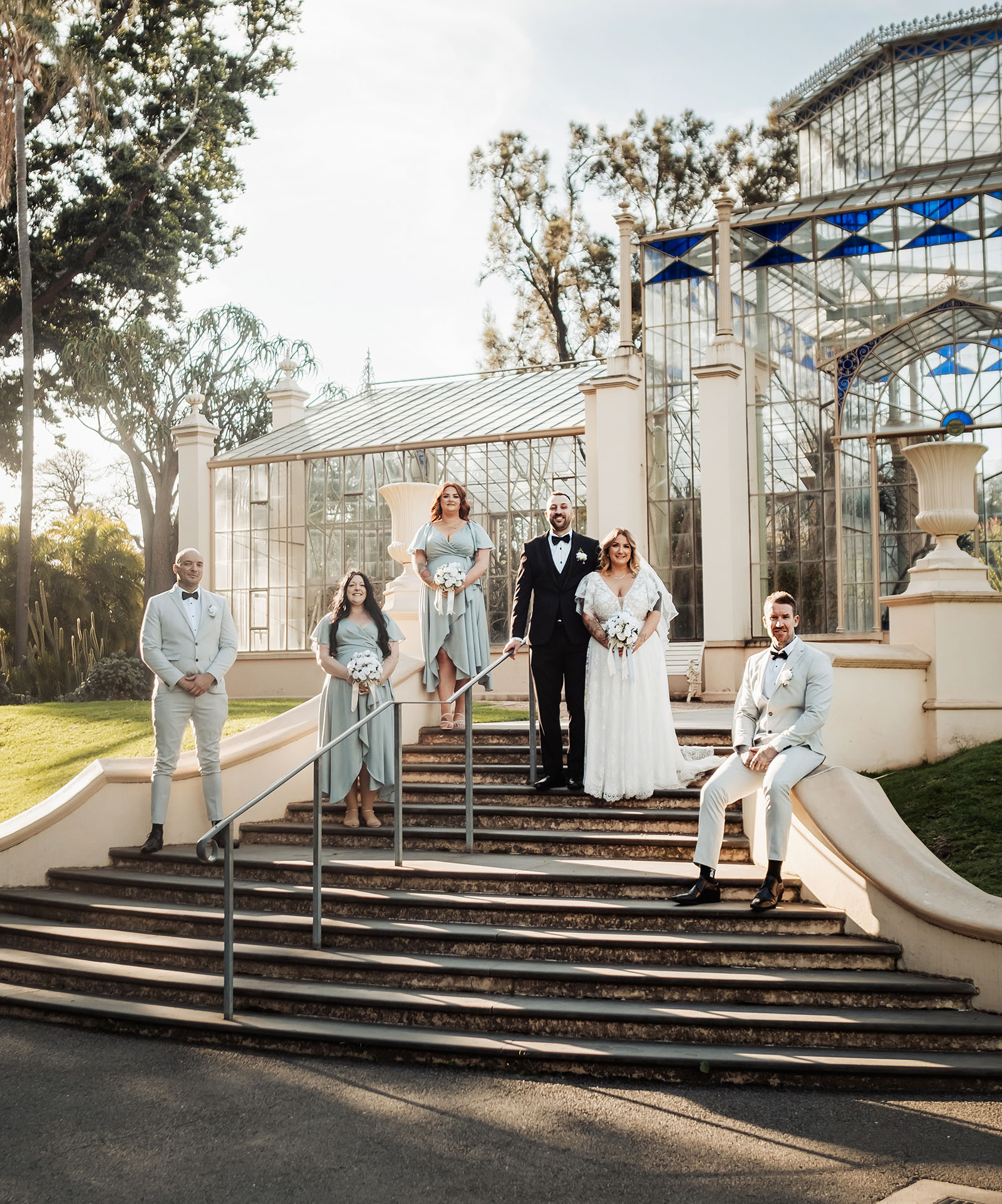 botanic gardens adelaide wedding - melanie & adrian 252 Wedding party posing elegantly on grand staircase.