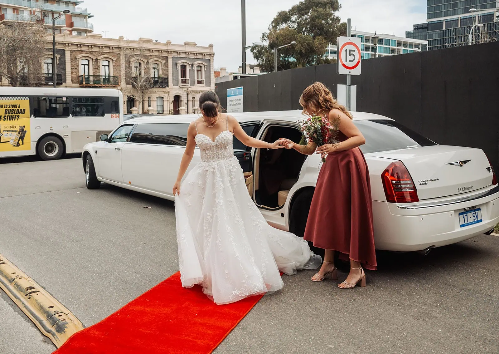 adelaide botanic gardens summerhouse wedding - belinda & ian 158 Bride stepping out of a limousine in a wedding dress.