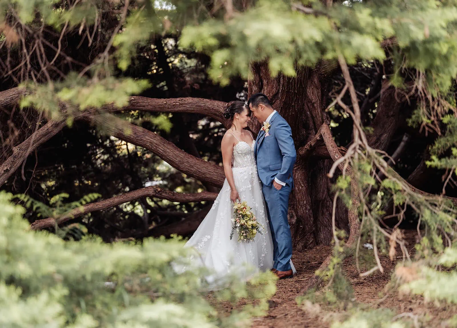 adelaide botanic gardens summerhouse wedding - belinda & ian 196 Bride and groom pose romantically in scenic nature setting at wedding.