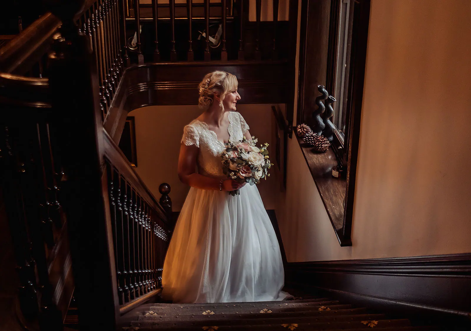 mt lofty house elopement - kimberley & michael 192 Bride in elegant gown descending grand staircase for wedding ceremony.