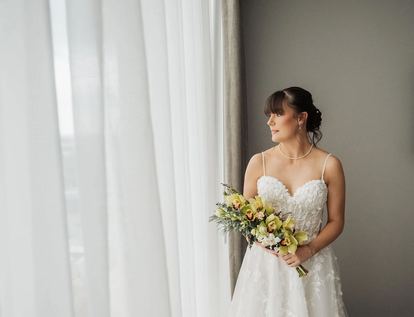 adelaide botanic gardens summerhouse wedding - belinda & ian 150 Bride gazes through window, capturing elegance and reflection on wedding day.