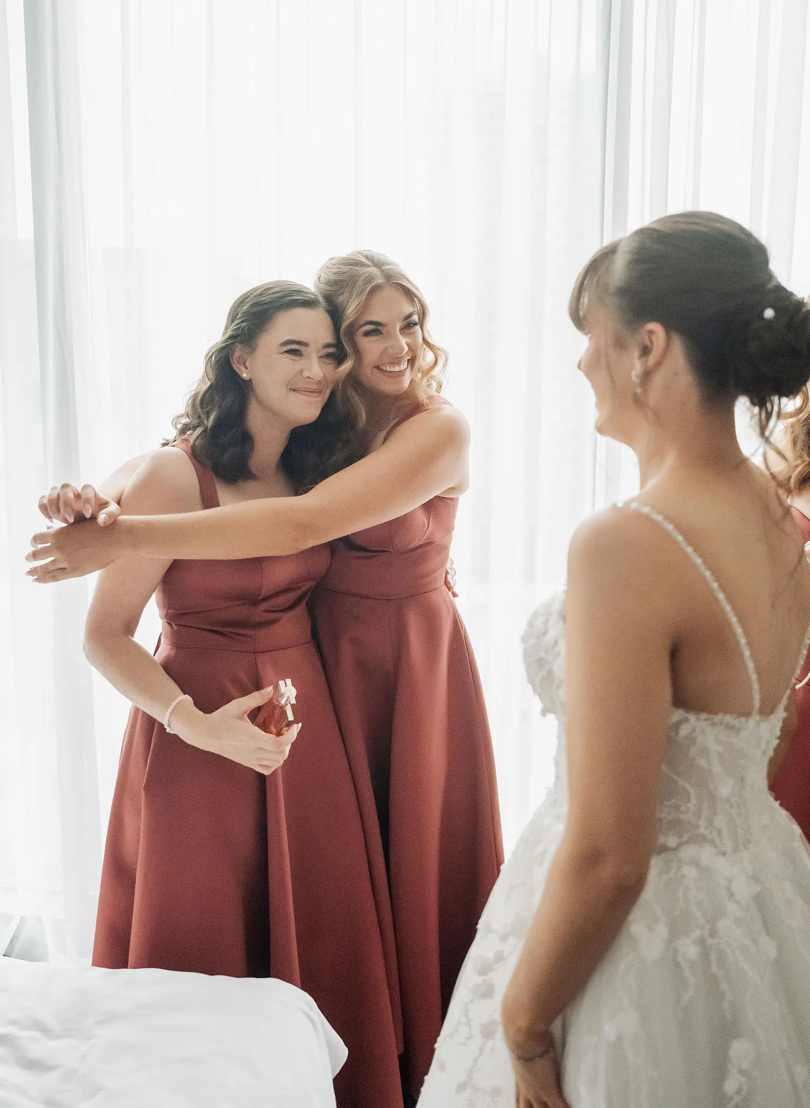 adelaide botanic gardens summerhouse wedding - belinda & ian 148 Bride laughing with bridesmaids, dressed in pastel gowns, capturing joyous wedding memories.