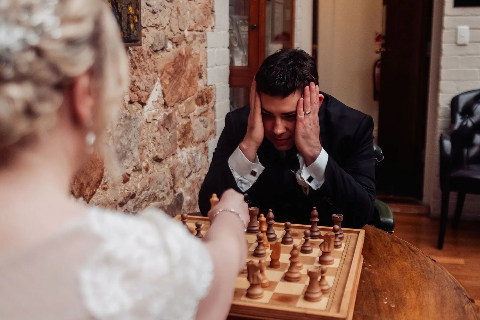 mt lofty house elopement - kimberley & michael 195 Intimate chess game between friends, focused and strategic atmosphere.