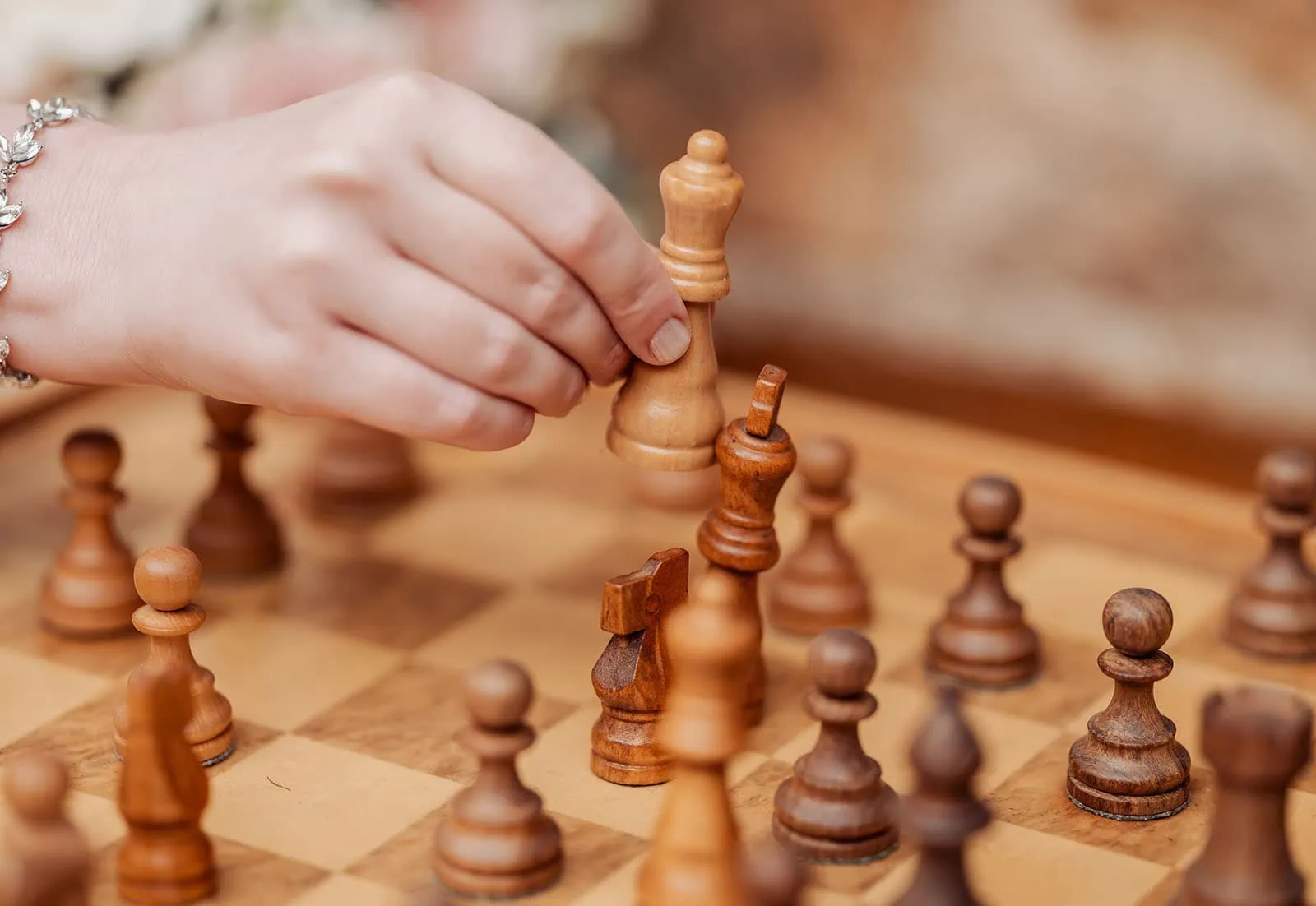 mt lofty house elopement - kimberley & michael 196 Close-up of a chess move, strategic board game decision in progress.