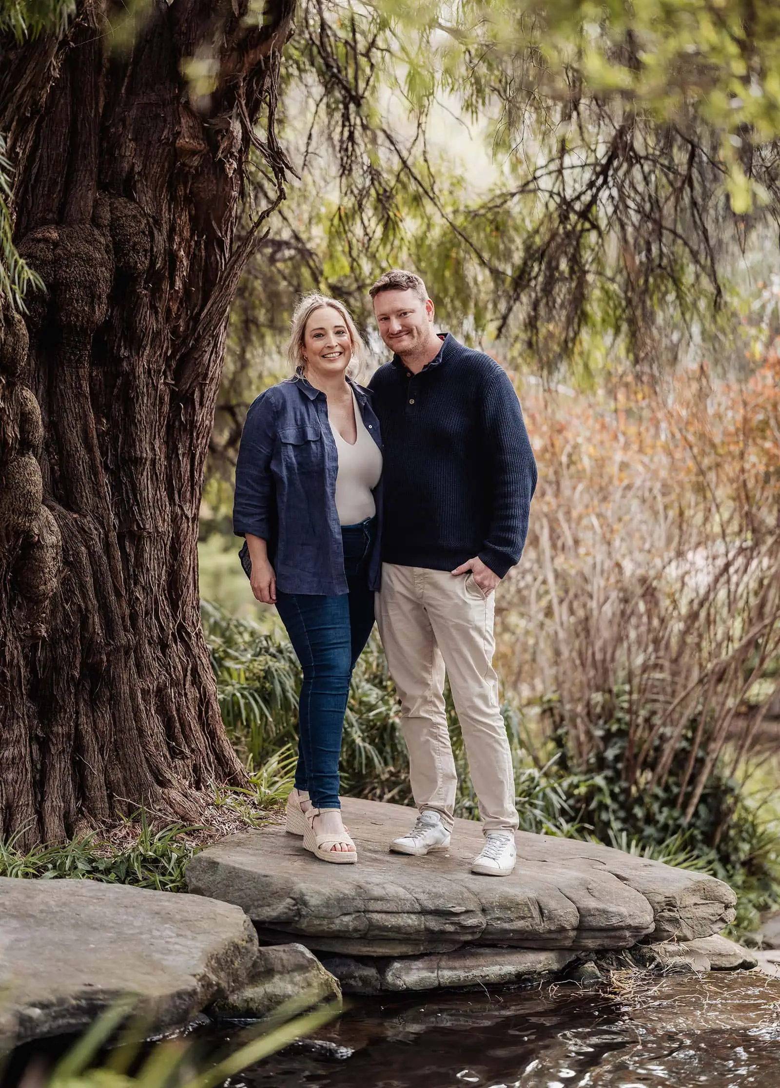 southern parklands family photography 23 Couple embracing under tree in autumn park, romantic outdoor date.