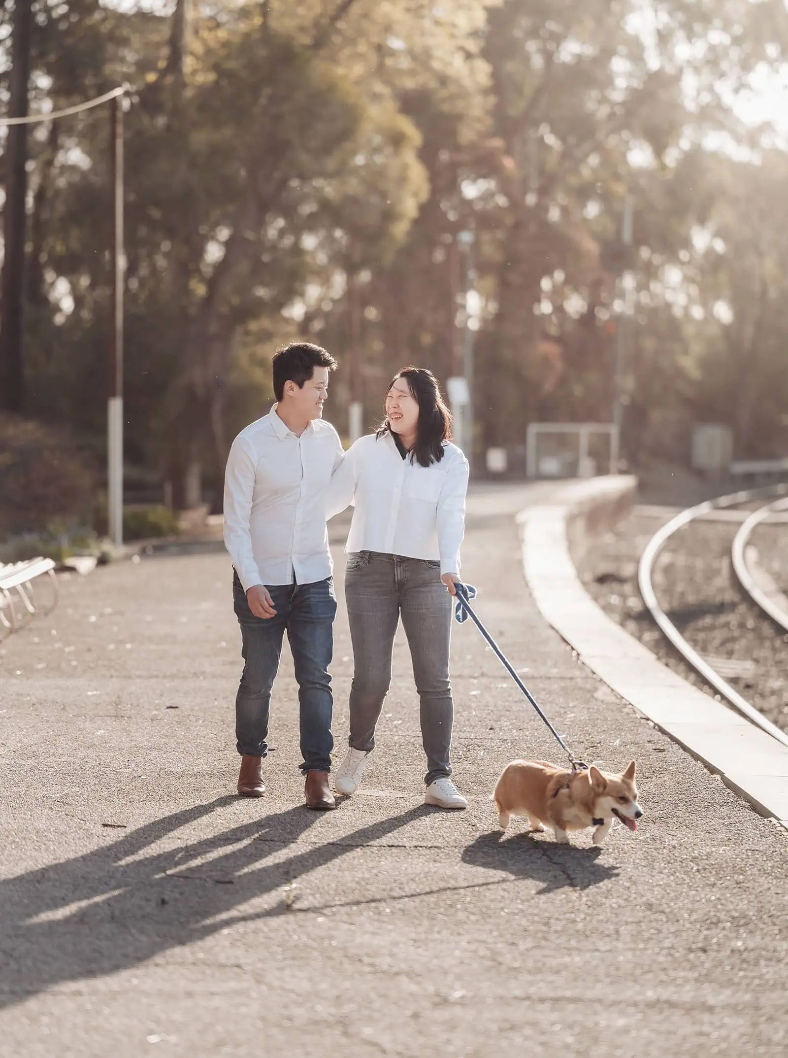 belair family photography 104 Couple with dog waiting on train platform.
