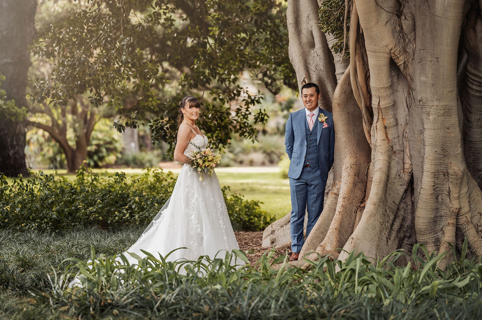 adelaide botanic gardens summerhouse wedding - belinda & ian 174 Couple enjoying a colorful garden in spring bloom.