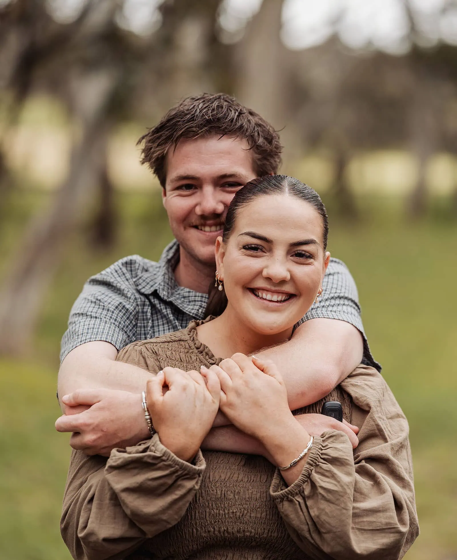 myponga family photography 15 Romantic couple embracing outdoors at sunset, sharing a warm moment.