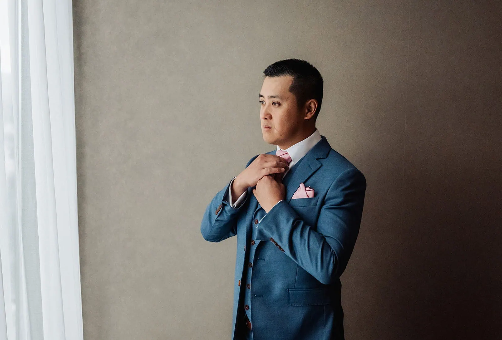 adelaide botanic gardens summerhouse wedding - belinda & ian 128 Man in elegant blue suit posing, showcasing fashion style and sophistication.