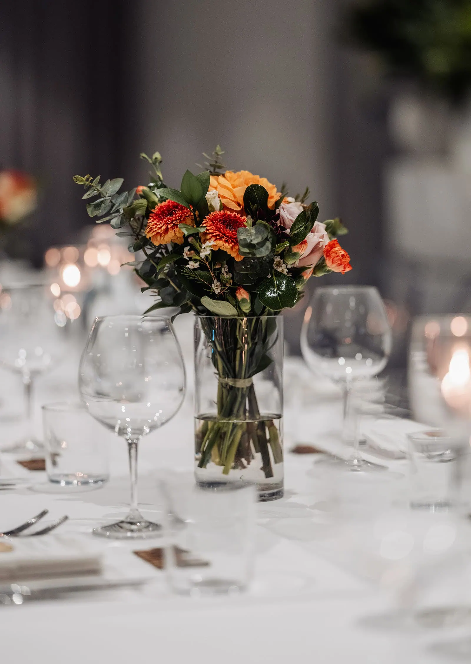 carrick hill wedding - jo & david 317 Elegant wooden dining table set with chairs, centerpiece, and tableware in a stylish dining room.