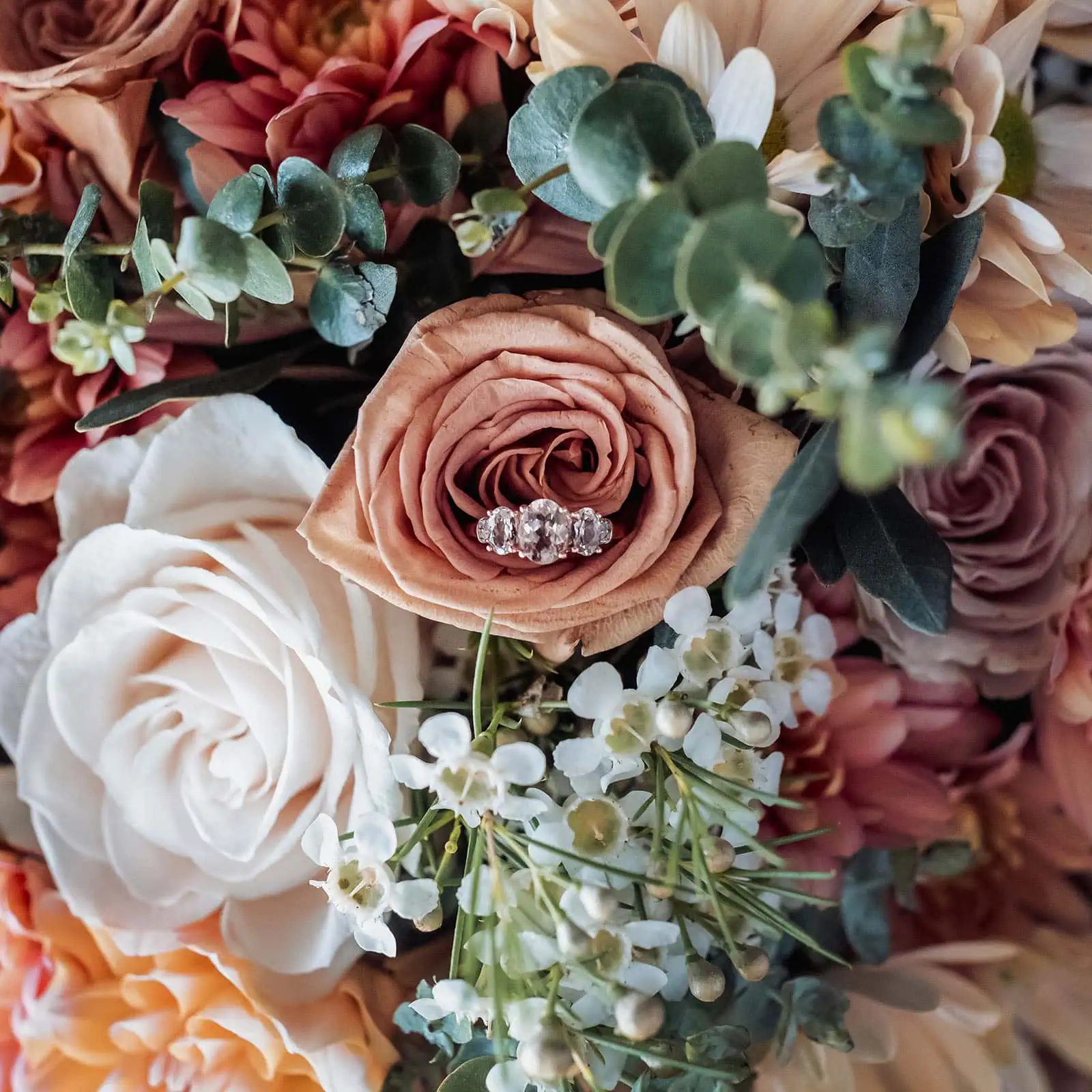 grand cru estate wedding - isabella & nick 107 Elegant floral ring arrangement with colorful blooms and lush greenery.