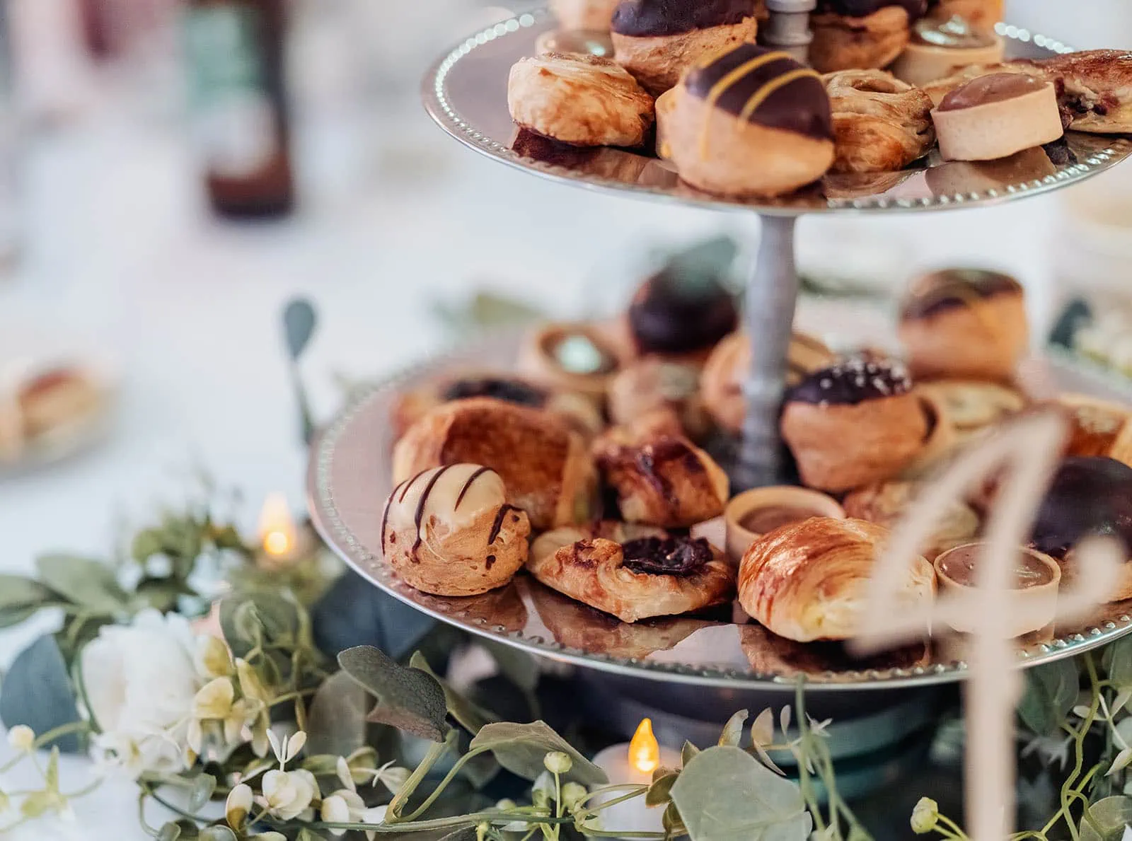 utopia waterfall gully wedding - sally & ben 260 Elegant pastry stand showcasing assorted gourmet desserts and sweets.