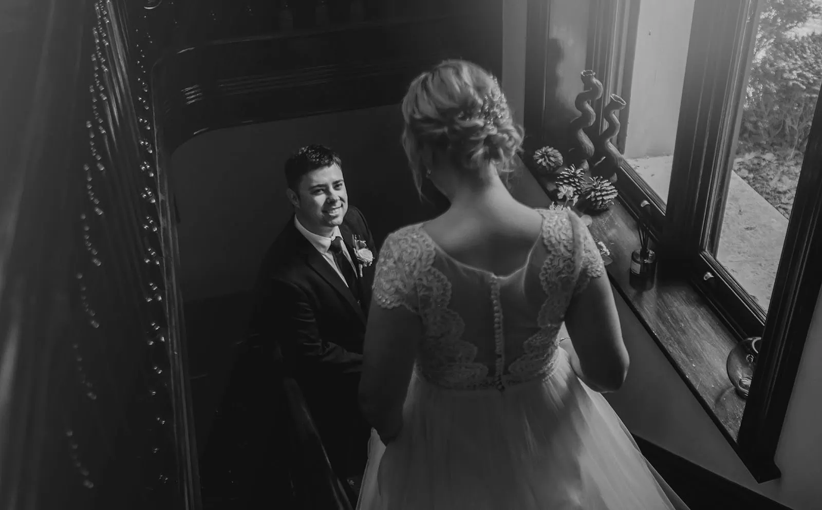 mt lofty house elopement - kimberley & michael 189 Elegant wedding couple sharing a romantic kiss amid stunning floral backdrop.