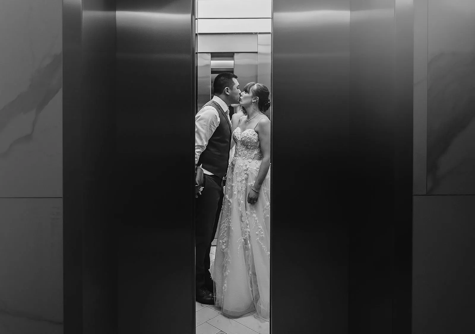 adelaide botanic gardens summerhouse wedding - belinda & ian 214 Romantic couple sharing a tender moment in elevator.