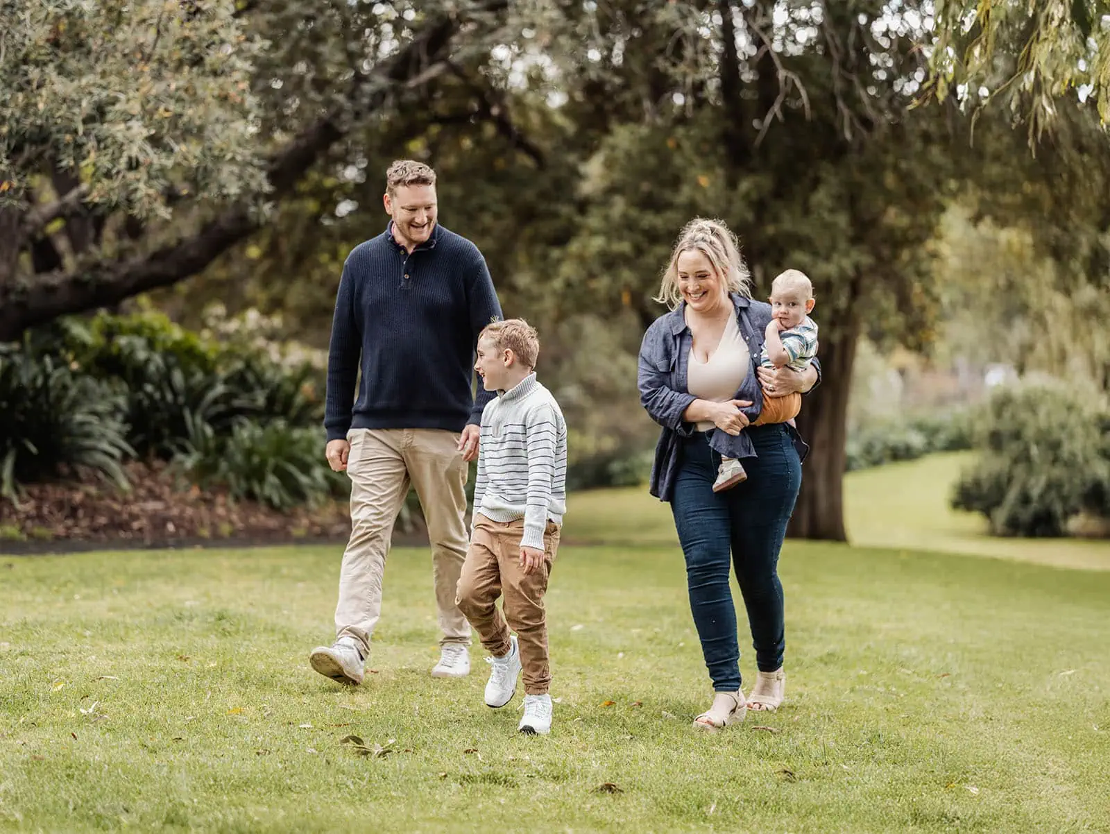 southern parklands family photography 31 Family enjoying a sunny park walk, bonding and nature exploration.