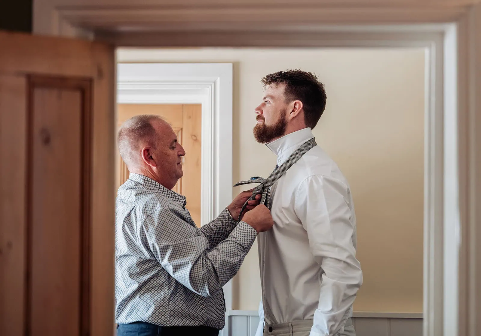 grand cru estate wedding - isabella & nick 109 Father helping son with tie, bonding, family values, parenting, fatherhood, life skills instruction.