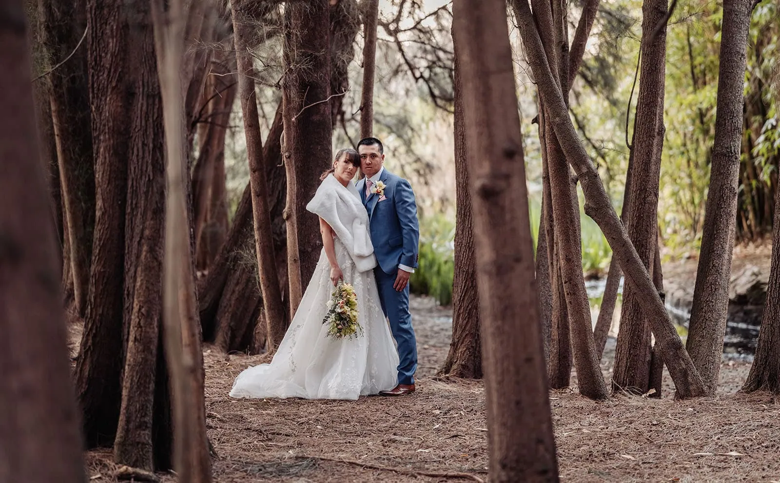 adelaide botanic gardens summerhouse wedding - belinda & ian 198 Bride and groom embrace in enchanting forest wedding setting.
