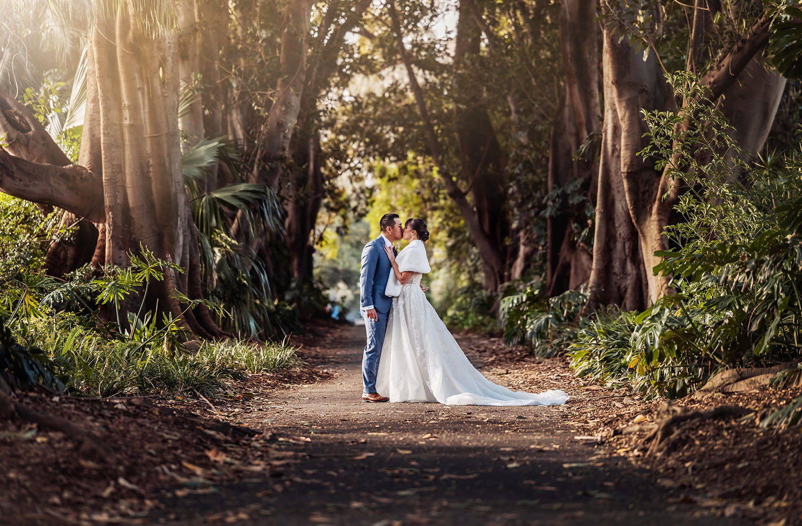 adelaide botanic gardens summerhouse wedding - belinda & ian 185 Bride and groom embrace in serene forest wedding setting.