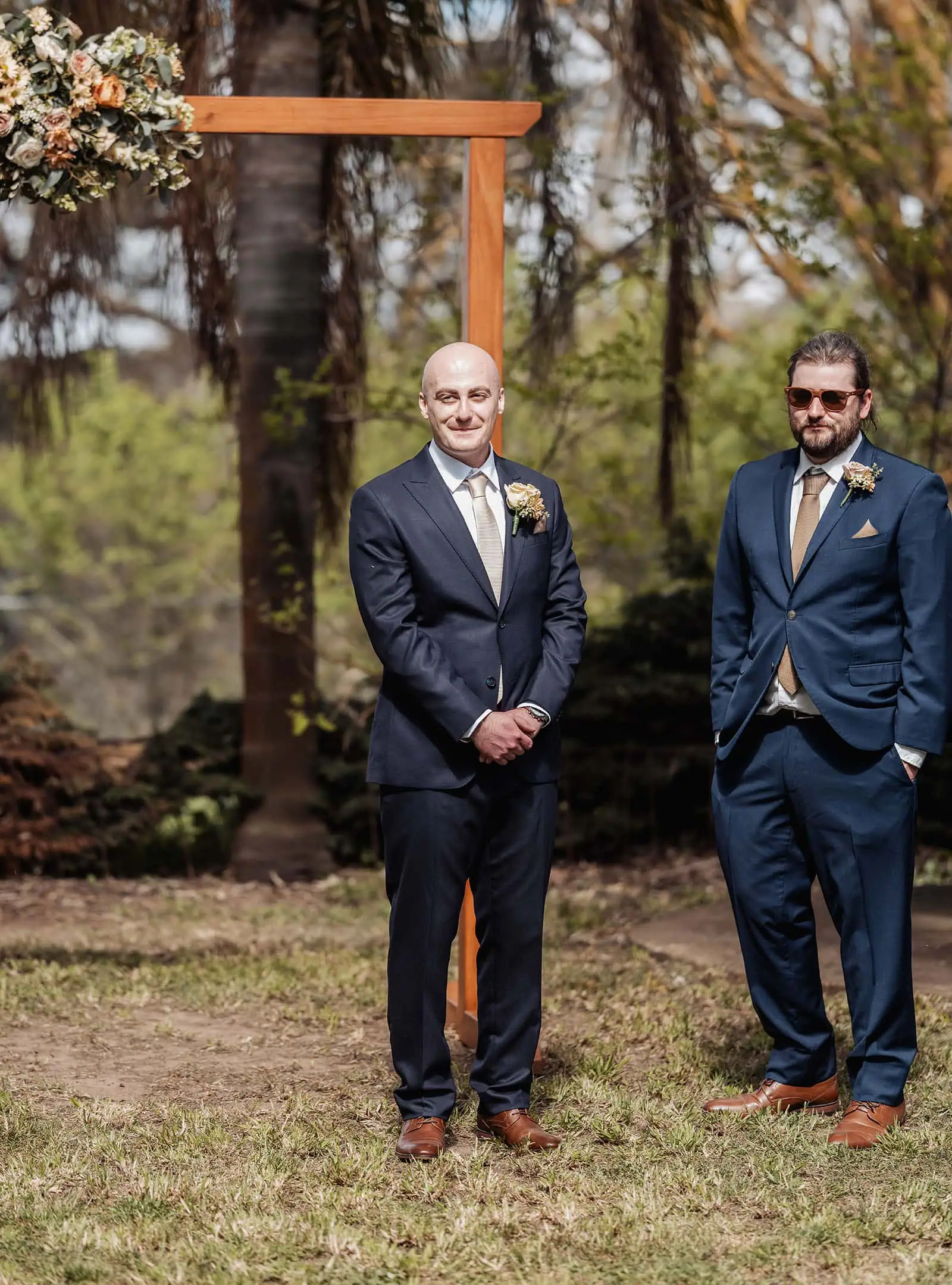 grand cru estate wedding - isabella & nick 119 Enchanting garden wedding ceremony under a floral arch with happy couple.
