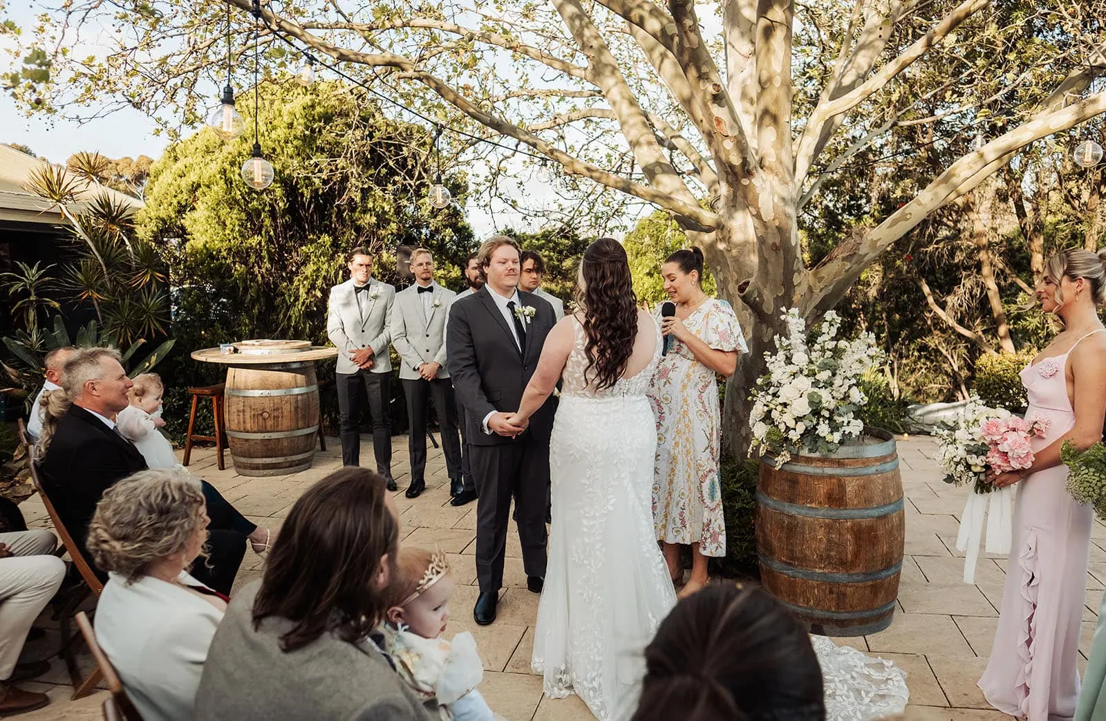 beach rd wines wedding - hana & jessie 63 Outdoor wedding ceremony in a blooming garden setting.
